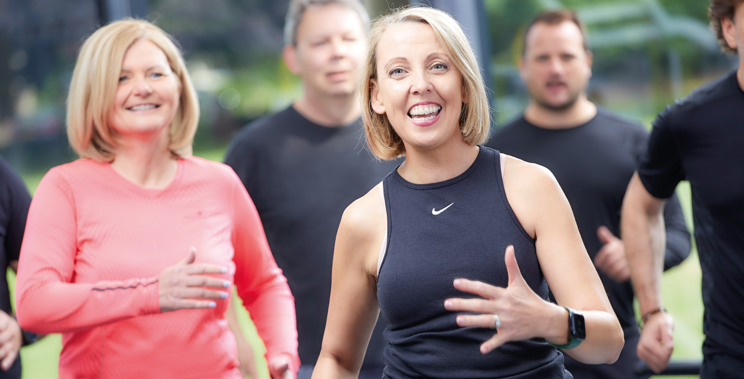 People smiling during a group fitness training session