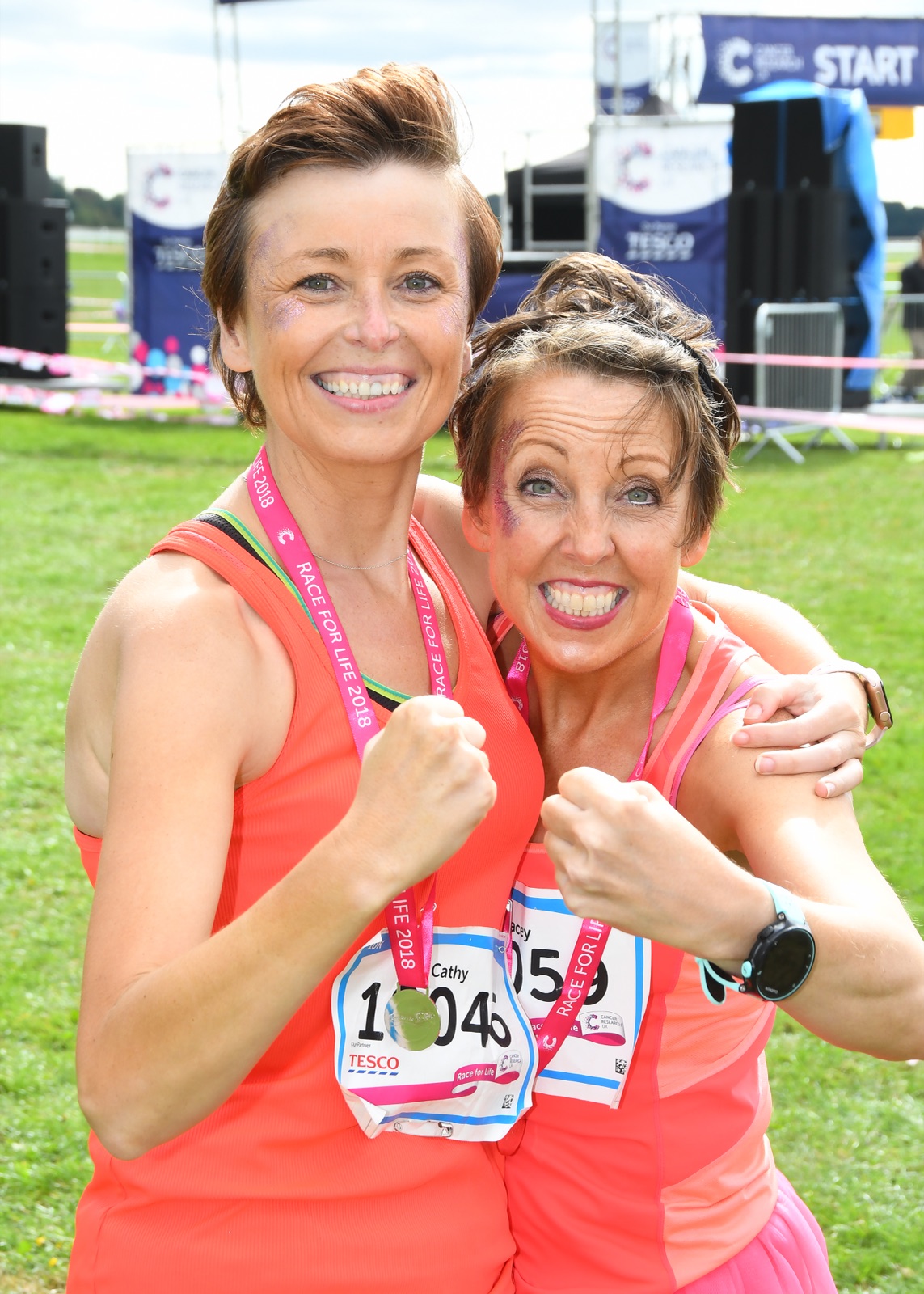 Cathy and Tracey celebrating with their medals at the Race for Life finish line