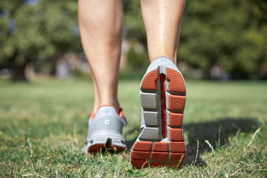 Person walking outdoors in running shoes to support long-term fitness and healthy ageing.