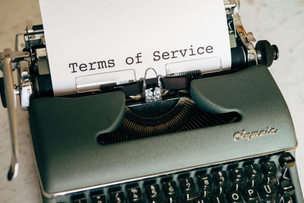 Close-up of a typewriter with paper showing the words “Terms of Service”.